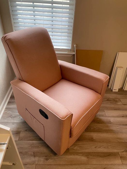 Reviewer image showing a side view of an orange rocking chair, with a side pocket and a black pull handle for easy reclining
