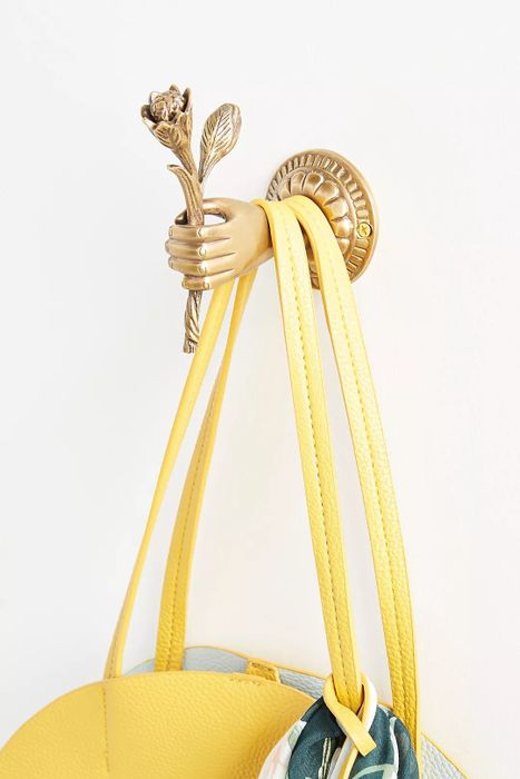 The bronze wall hook holding a purse