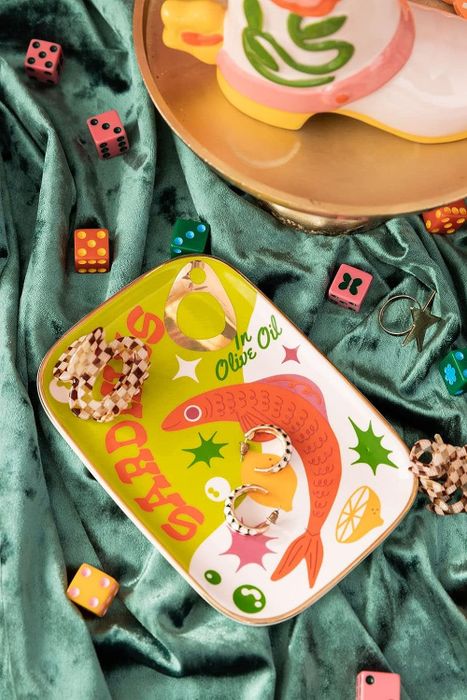 A colorful, illustrated sardine can trinket tray.