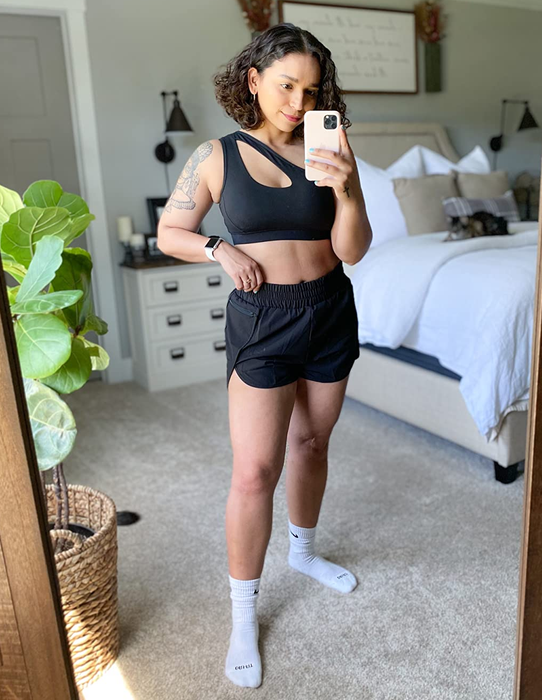 A reviewer wearing the black shorts