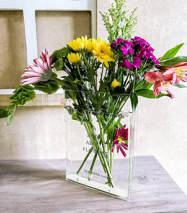 A reviewer's transparent vase filled with a colorful mix of fresh flowers, sitting gracefully on a table and adding a touch of elegance to home decor