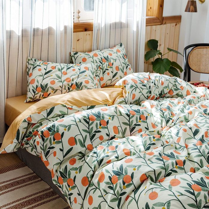 The white and green duvet set featuring an orange pattern.