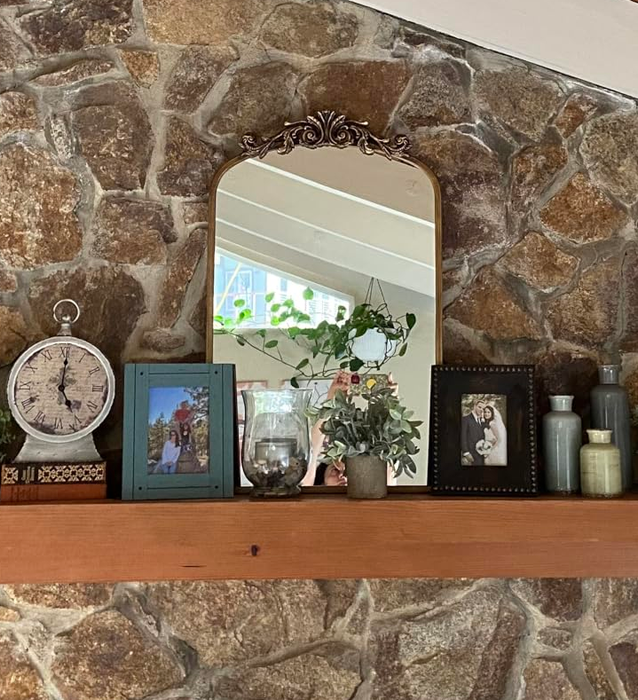 Another reviewer’s mirror resting gracefully on a fireplace mantle