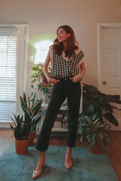 A reviewer pairing the same sweater vest with raw hem jeans and kitten heel pumps