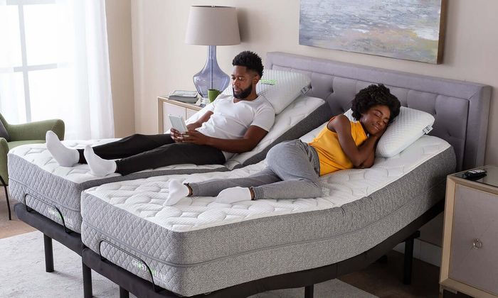 A couple relaxing on a split king adjustable bed.