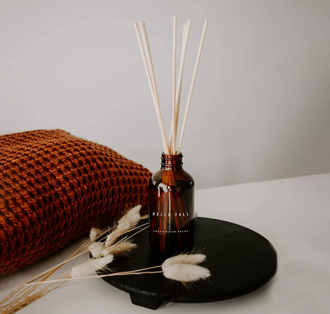 A reed diffuser sitting on a decorative tray, adding warmth to the room.