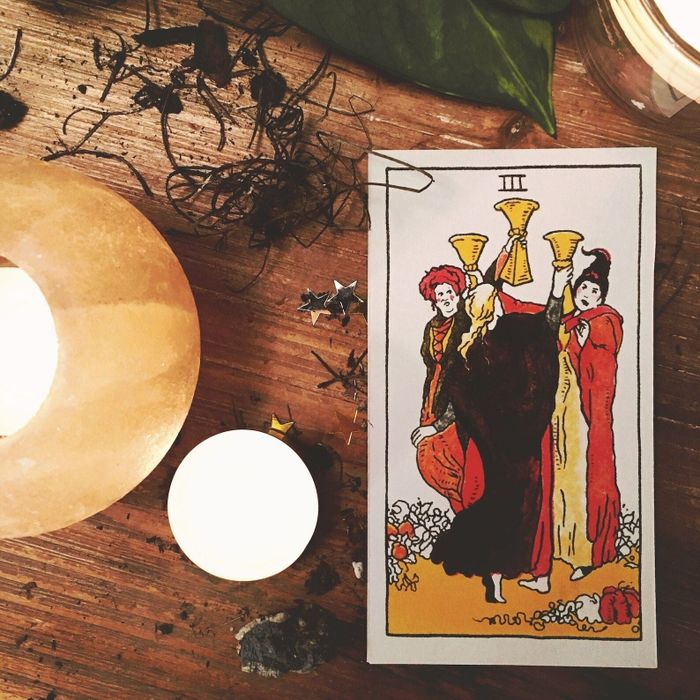 one card showing the Sanderson sisters joyfully dancing in a circle