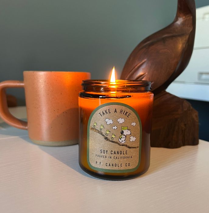 A lit soy candle titled 
