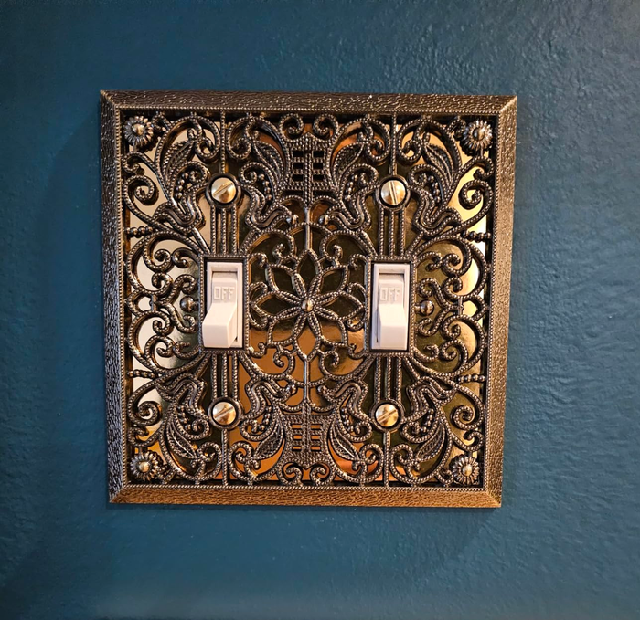 A reviewer's double toggle filigree wallplate cover displayed in all its elegance