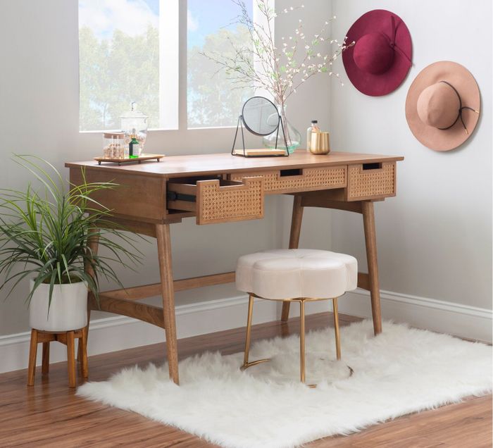 The desk is being used as a vanity with one drawer open.