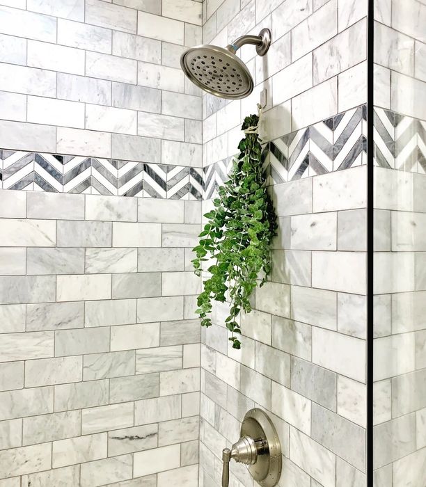 A bundle of eucalyptus elegantly hanging from the shower head, filling the space with natural fragrance