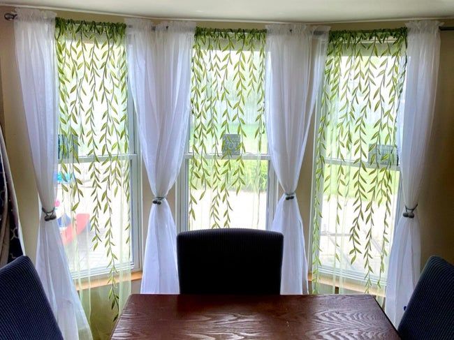 Drapes hanging across three windows