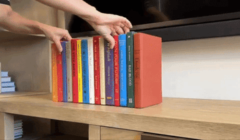 A gif showing someone revealing the concealed area behind the faux book display