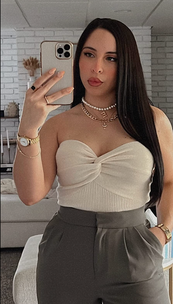 Another reviewer styles the top tucked into high-waisted pants.