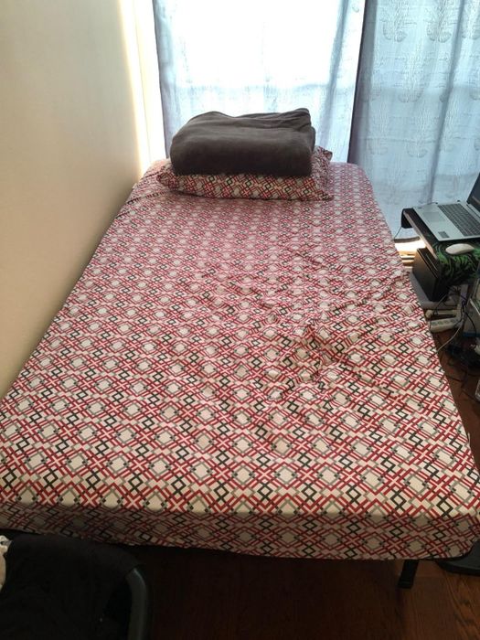 photo from a reviewer showing bedding on top of a twin bed frame
