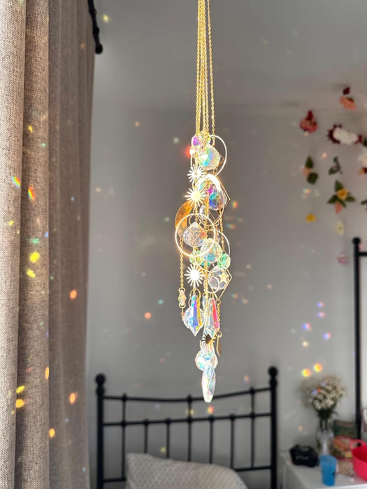 Crystal suncatcher hanging, casting reflective patterns on the walls