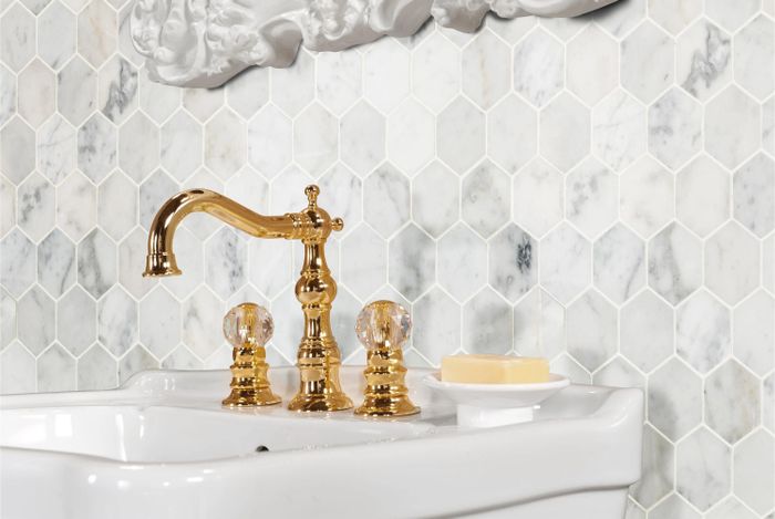 The honeycomb-patterned tile used as a sleek backsplash behind a bathroom sink