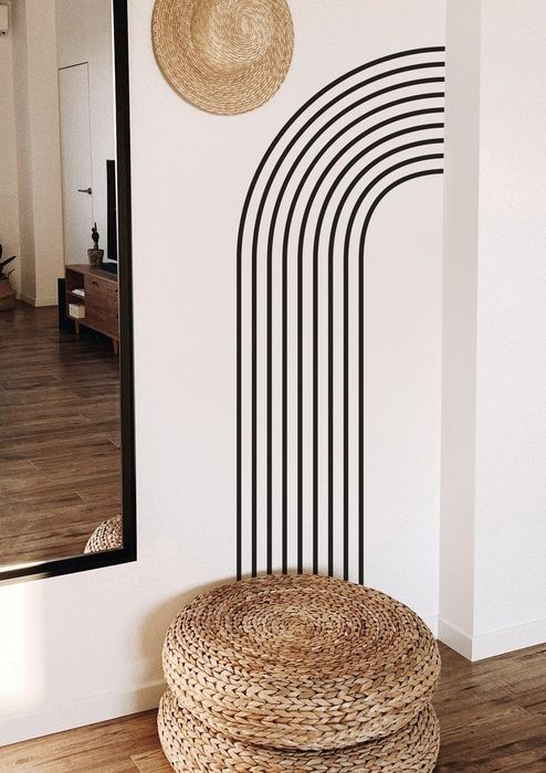 Black arch wall decal placed beside a mirror.