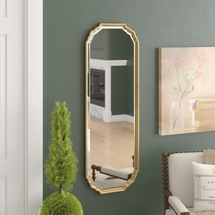 The elegant arched mirror with curved corners hanging gracefully in a room.