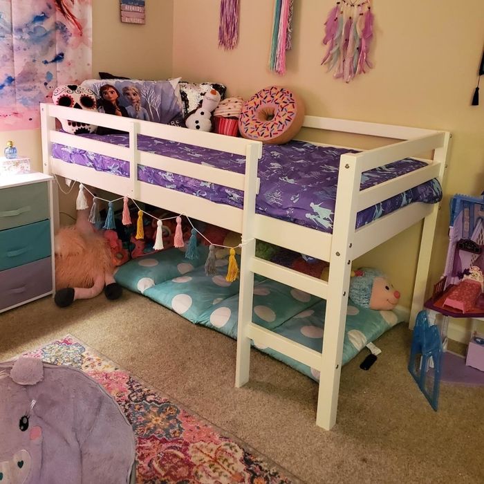 A photo of a white lofted bed frame with a play area beneath it, taken by a reviewer.