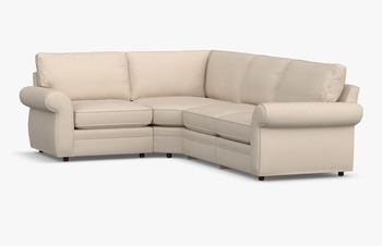 Lifestyle image of a white rolled-arm sectional sofa.