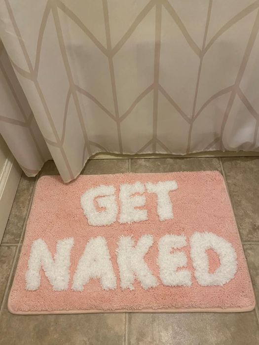 A bathroom mat featuring a humorous phrase, perfect for adding personality to your space.