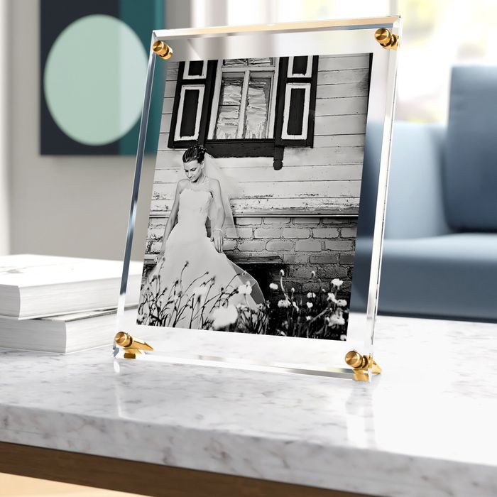 The stylish picture frame showcasing a photo on a table.