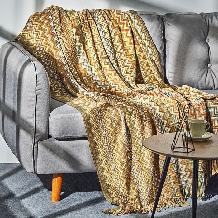 the throw blanket draped over a couch