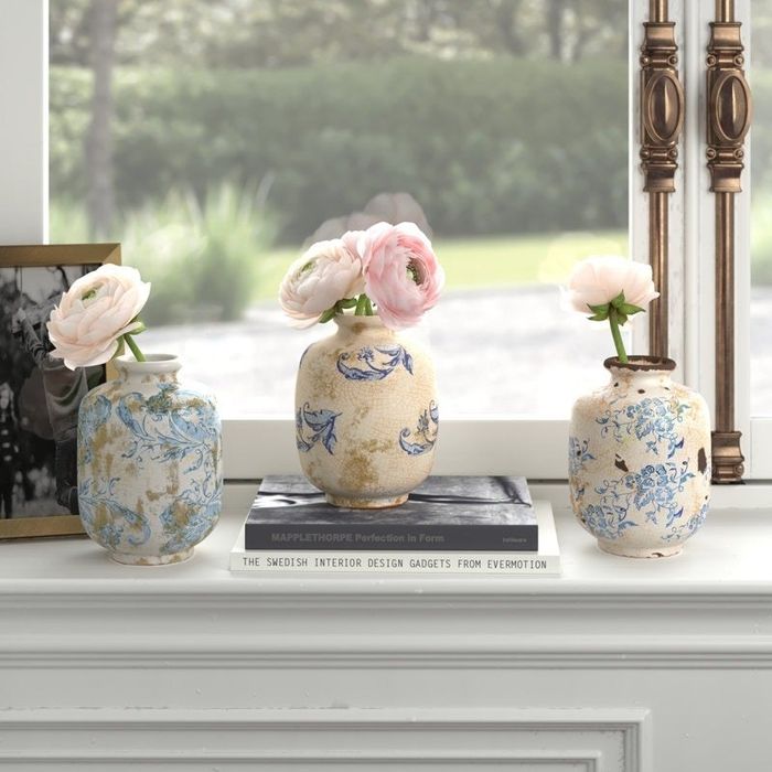 The white and blue round vases arranged on a shelf.