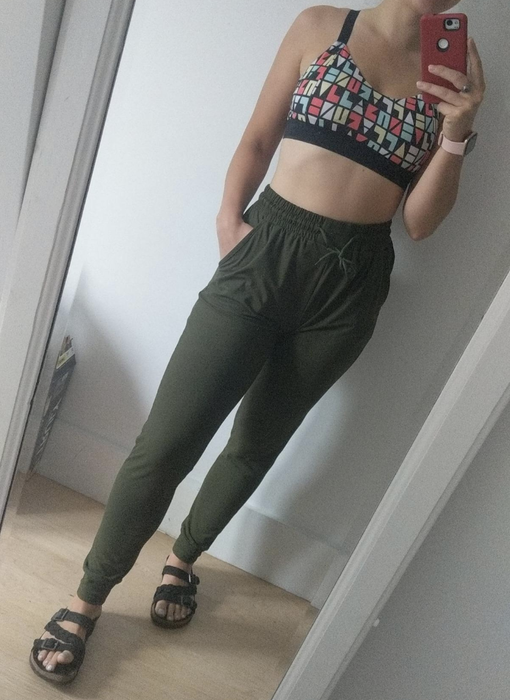 Reviewer wearing dark green joggers with an elastic drawstring high waist