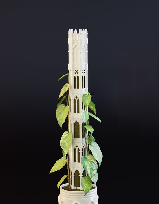 A decorative plant tower designed to resemble Gothic architecture, with greenery climbing through its arches and windows.