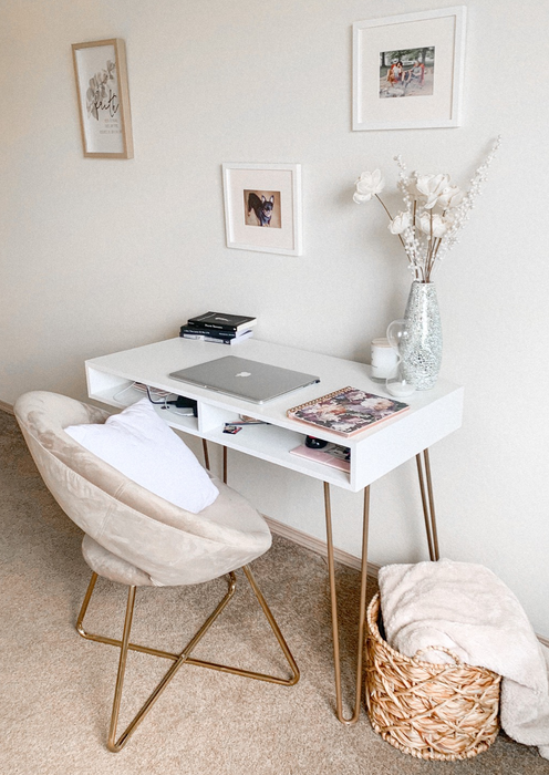 A reviewer sits in the white velvet chair at their desk