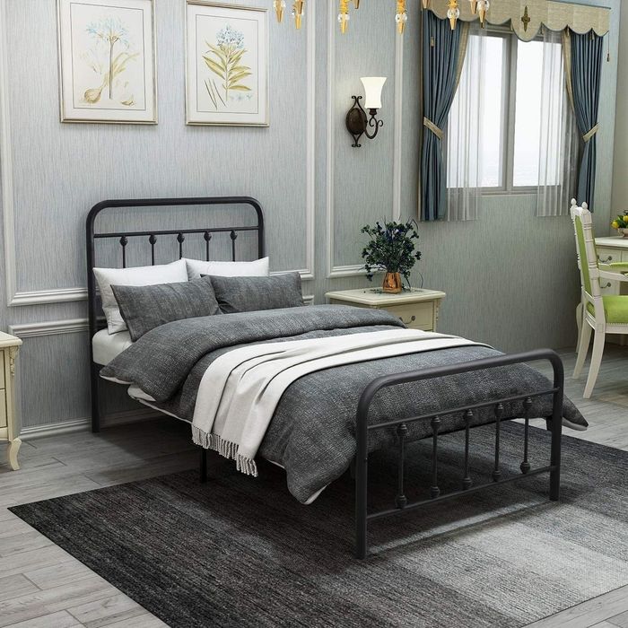 Lifestyle image of the bed in black set against a bedroom with gray walls.