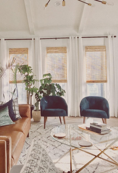 A reviewer demonstrates three blinds hanging neatly in their window.