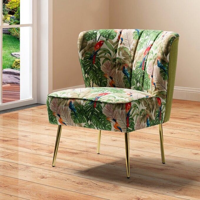 A reviewer photo of a green and white floral print chair.