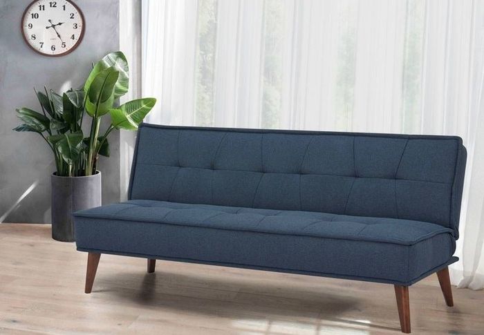 A navy blue futon bed in a living room