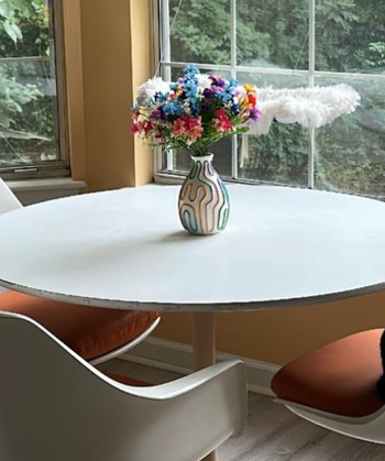 A vase sitting elegantly on a table, adding character to the space.