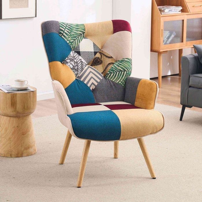 Modern patchwork armchair featuring geometric and leaf patterns with wooden legs.