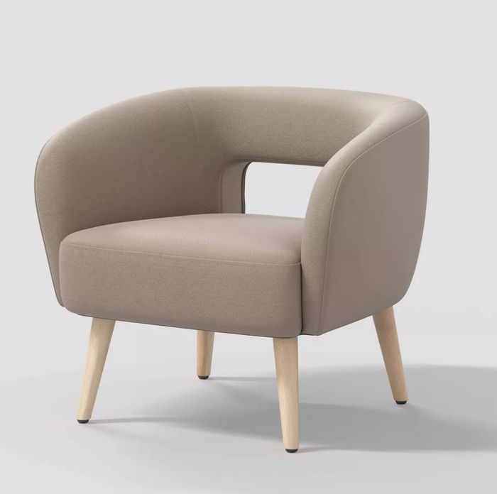 Modern armchair featuring a curved backrest, wooden legs, and an open back design.