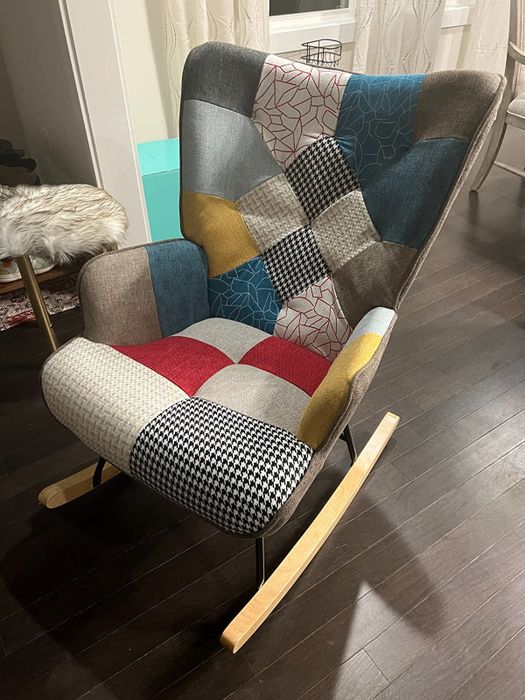 A reviewer's photo featuring a patchwork rocking chair.