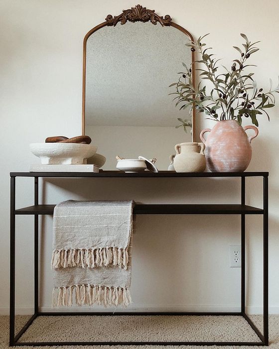 A reviewer’s mirror placed on a console table.