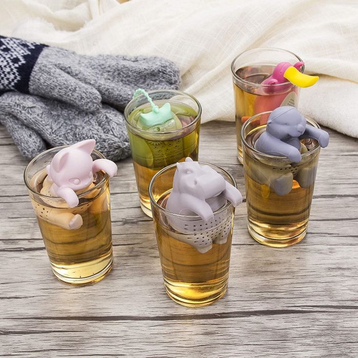 Animal-shaped tea infusers brewing tea in clear glass cups
