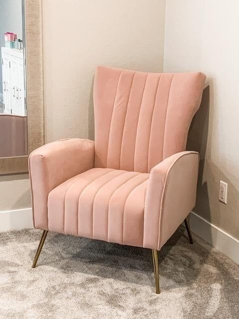 A reviewer's image showcasing a pink armchair.