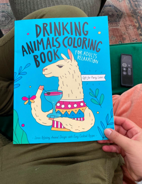 Reviewer holding the Drinking Animals Coloring Book