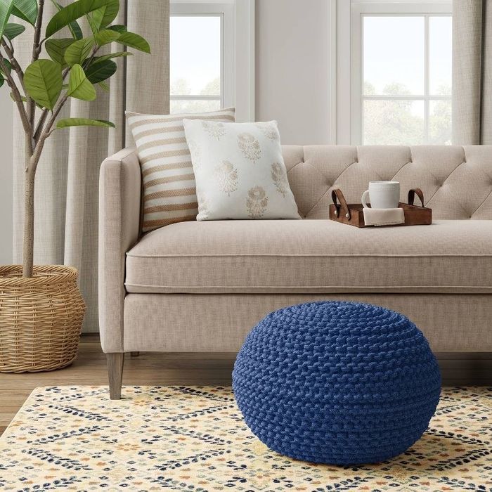 A blue knit pouf in a living room