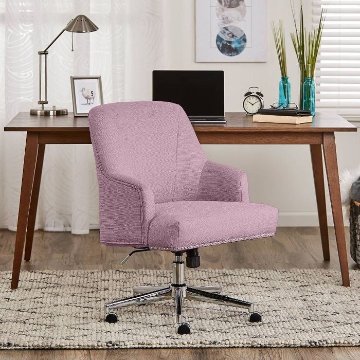 A lilac office chair placed next to a wooden desk