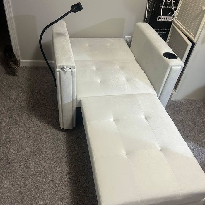 A modern daybed with an adjustable headrest.