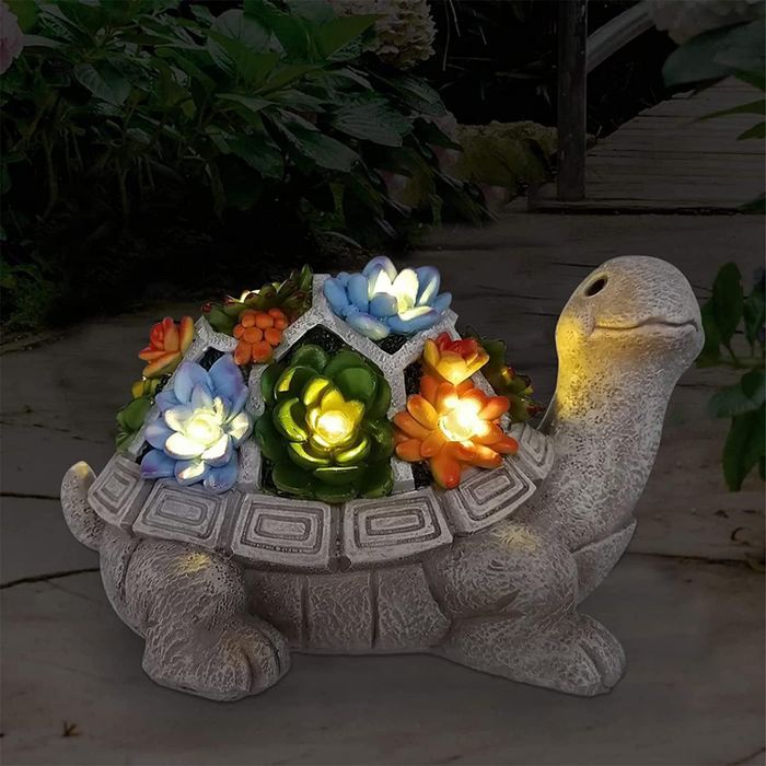A gray ceramic turtle with glowing flowers on its back
