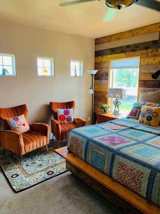 A reviewer's photo featuring two orange chairs in a cozy bedroom.