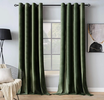 Two rich green velvet curtains hanging gracefully.